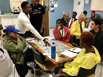 A discussion around a table of plans